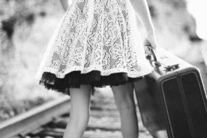 a confident woman - girl walking with luggage