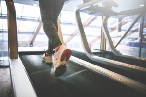 a confident woman - running on the treadmill