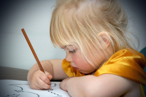 Little girl writing a letter - discussing the scary stuff with your child