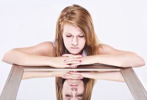 Overcome your low self-esteem - girl looking sad at her depression