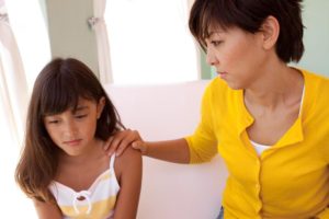 Depression in Teen Girls - Mom and daughter talking in Yellow