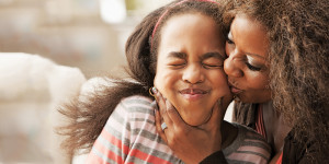 Raise Your Child's Self-Esteem - Mother kissing Daughter