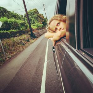 Girl riding on the side of a car; talking to her about her period.