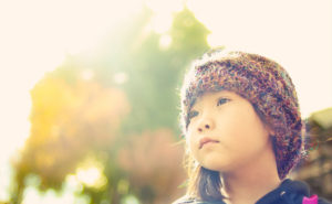 girl looking off into the sun - discussing the scary stuff with your kids