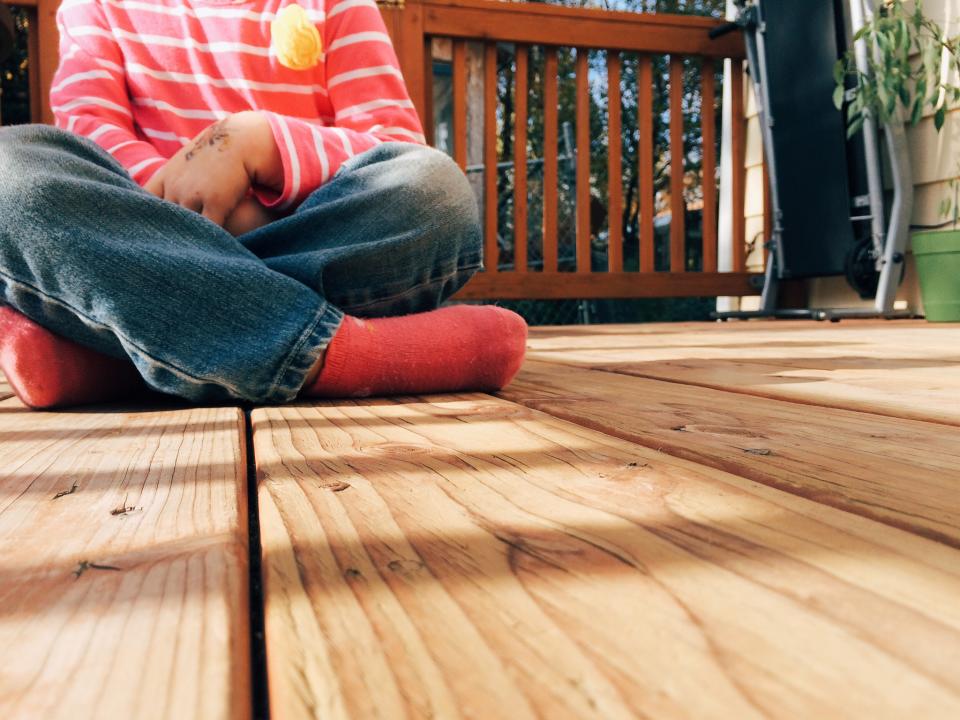 Girl sitting crossed on the porch - It can be hard to talk to your child about scary stuff. Terrorism and tragedy are not easy for anyone. Here are several ways to talk to your kids about it.